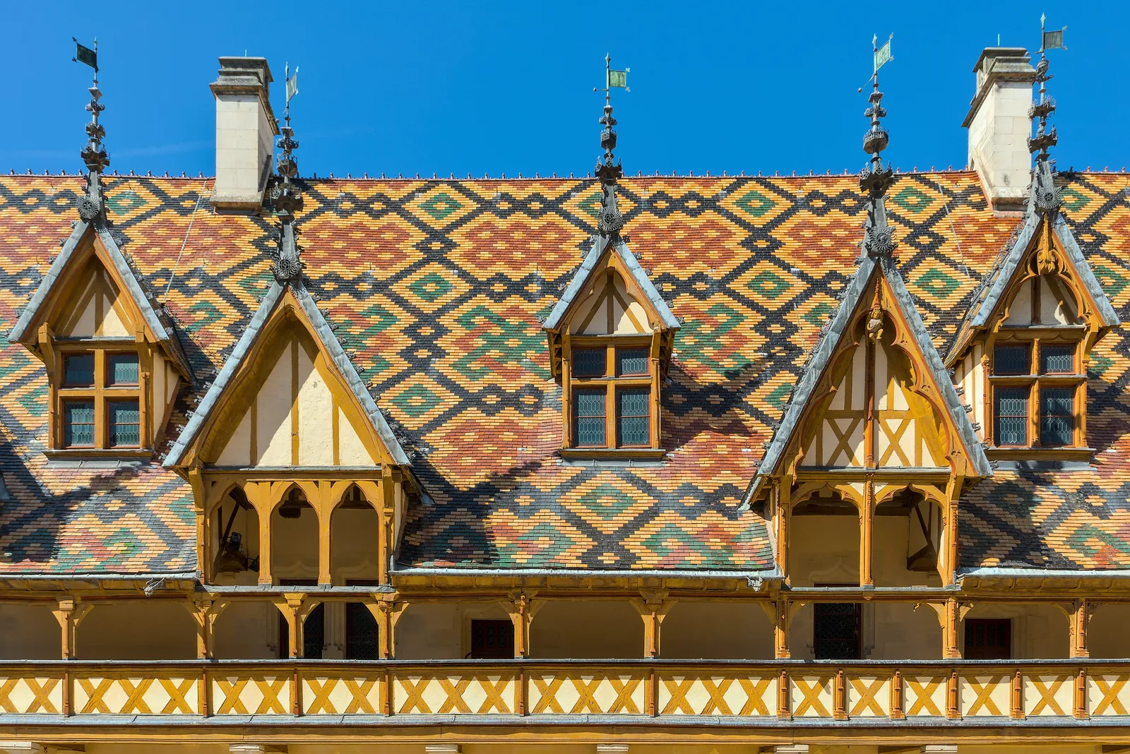 The glazed tile roof and dormers of the Hôtel-Dieu courtyard in Beaune